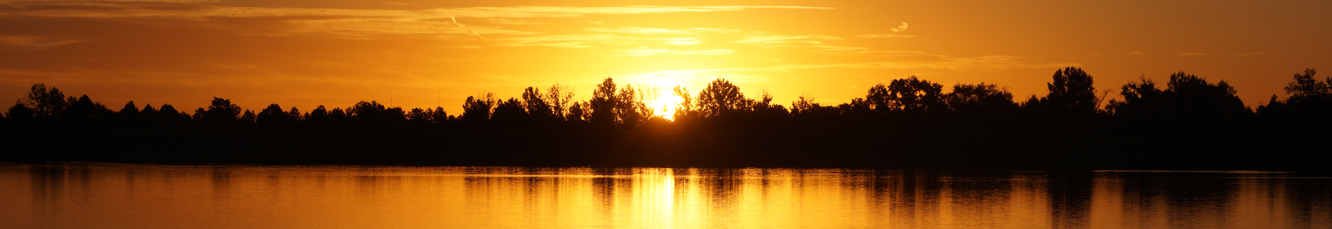 Sunrise at Lagerman Reservoir with striking yellow and orange colors.