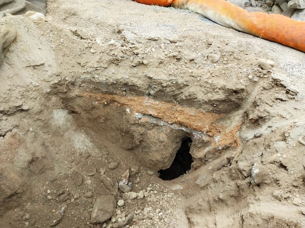 The opening of the hole that sites below the trail surface.