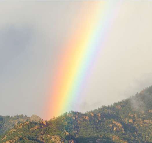A rainbow over a mountain