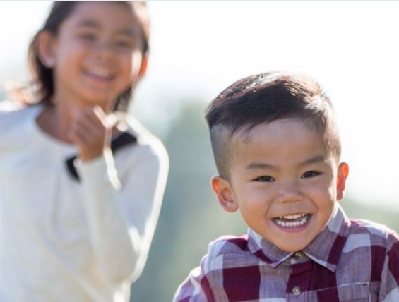 Young boy and girl running