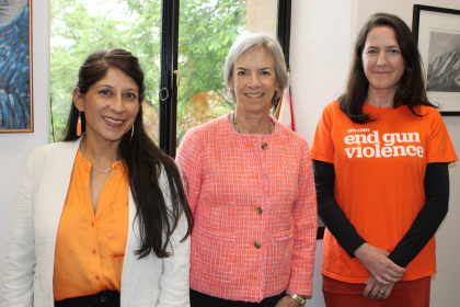 Boulder County Commissioners Marta Loachamin, Claire Levy, and Ashley Stolzmann wearing orange shirts.