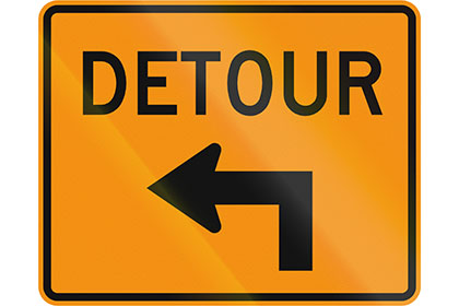 Orange detour sign with black text and arrow