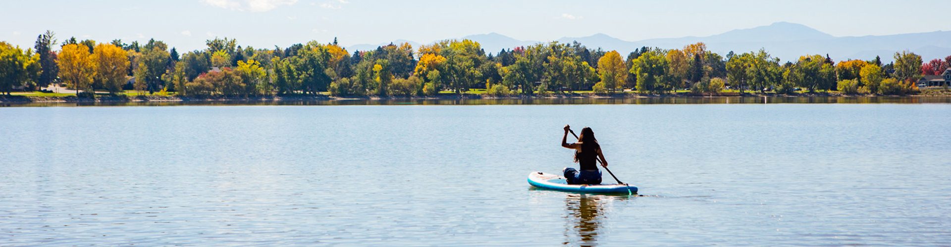 woman paddleboarding at lake macintosh in longmont
