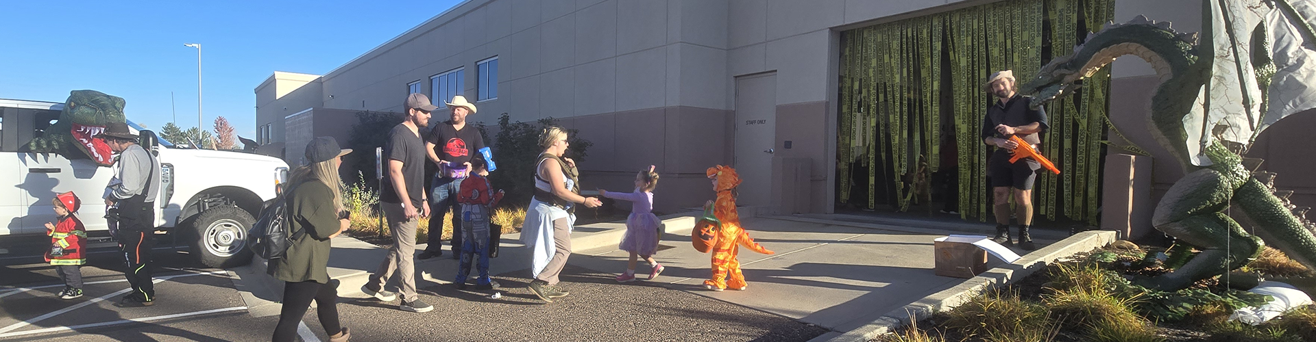 Families and kids in costume at the trunk or treat event