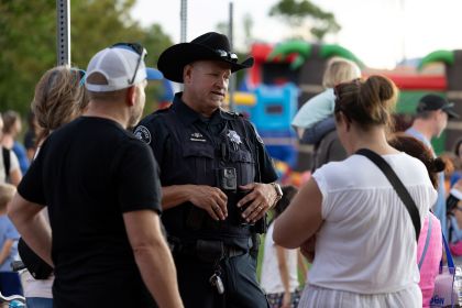 Sheriff deputy talking to community members at National Night Out.